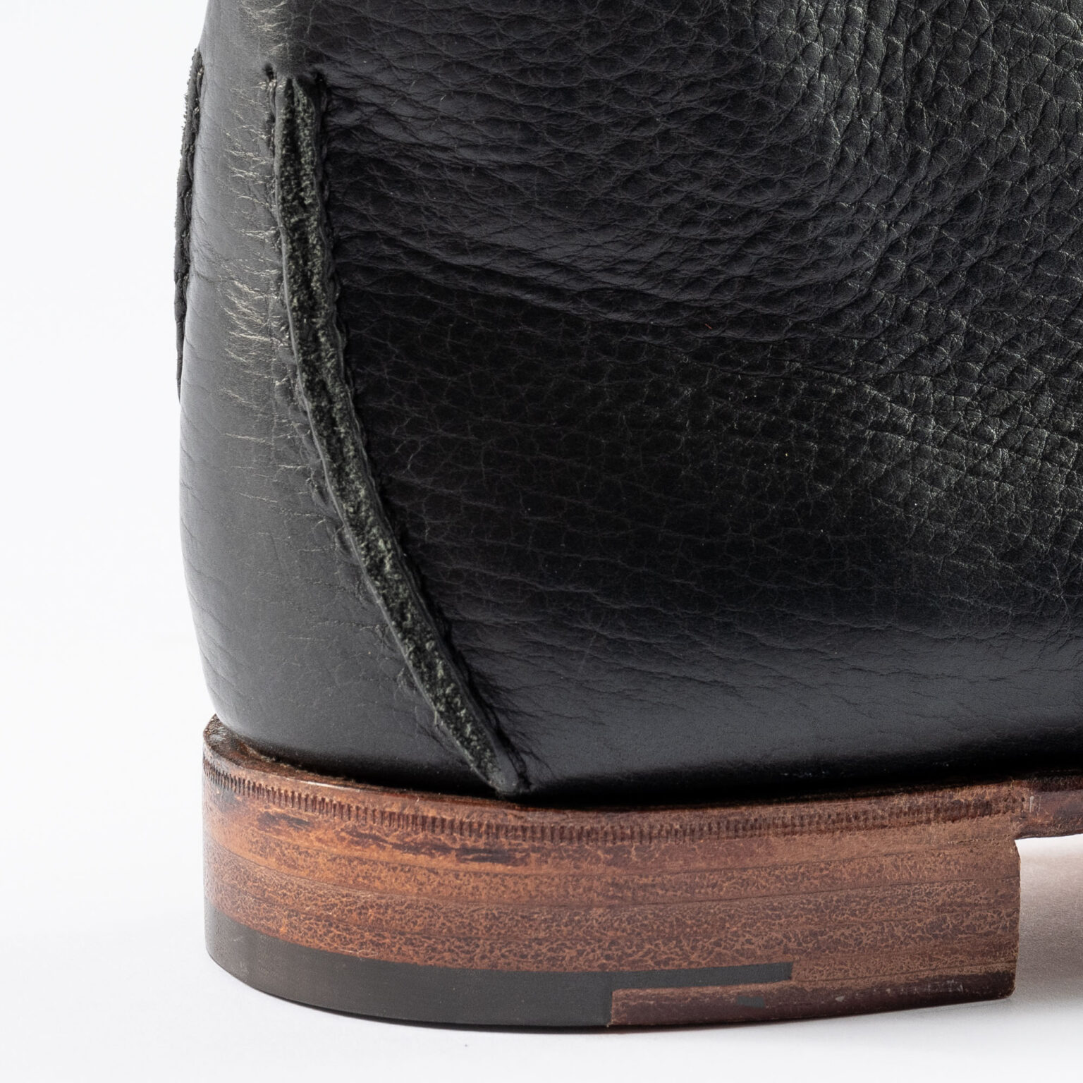 Closeup of raised seams on rear of Edgware Ankle Boot in Black Horween Veg Tanned Bison