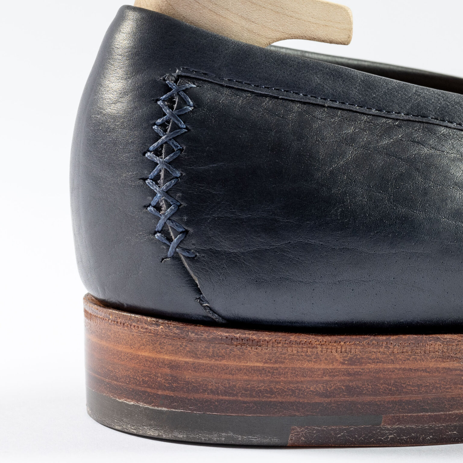 Closeup of backstrip on Fen Baseball Loafer in Navy Horween Veg Tanned Bison