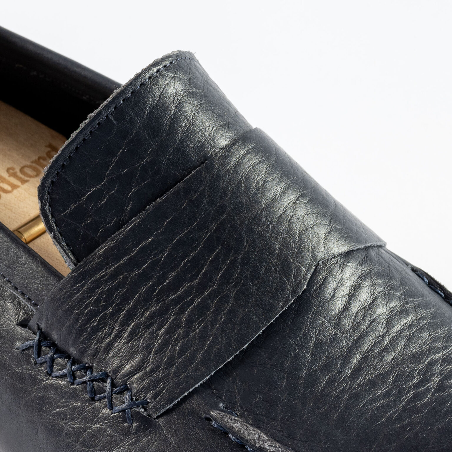 Closeup of stitched strap on Fen Baseball Loafer in Navy Horween Veg Tanned Bison