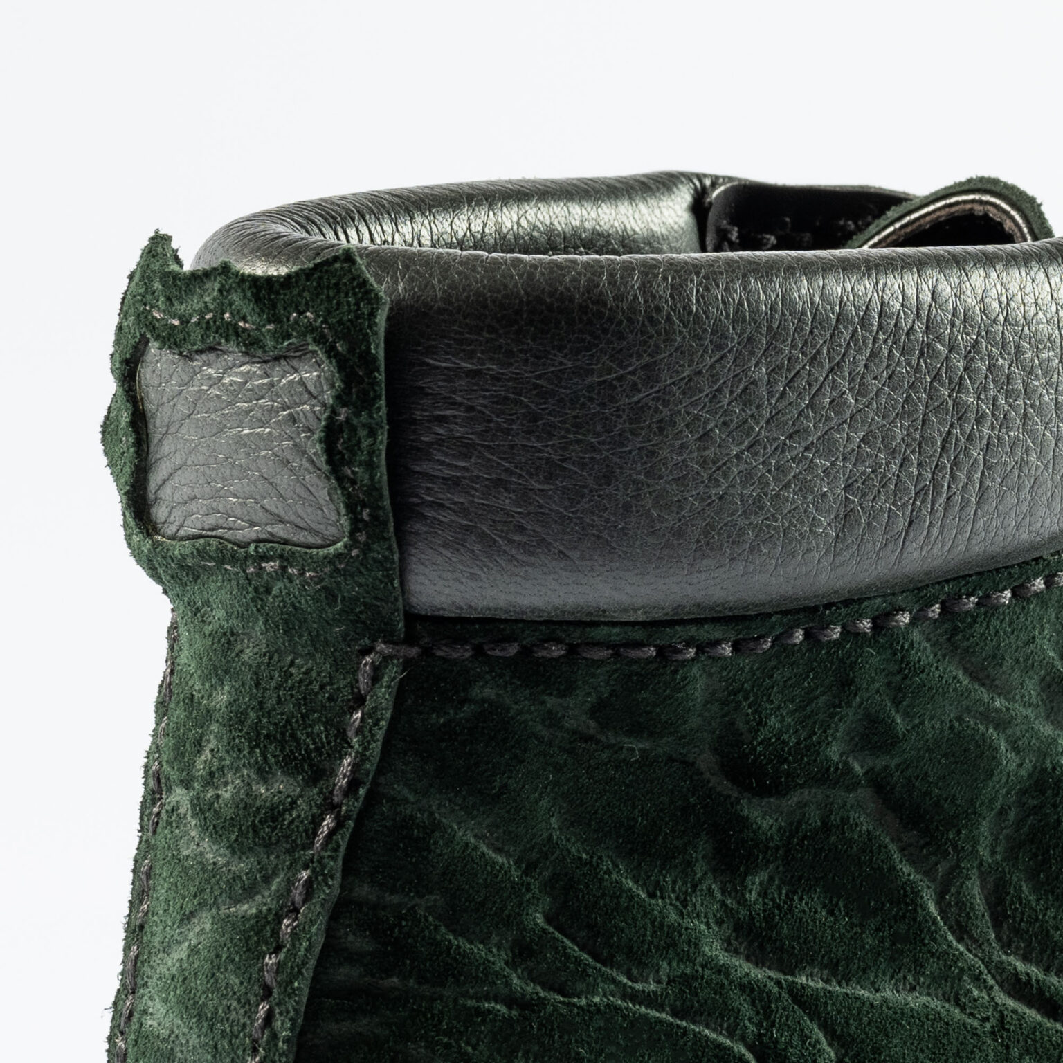 Closeup of shield and backstrip of Foxley Padded Ankle Boot in Racing Green CF Stead Janus Calf with Edwin emboss