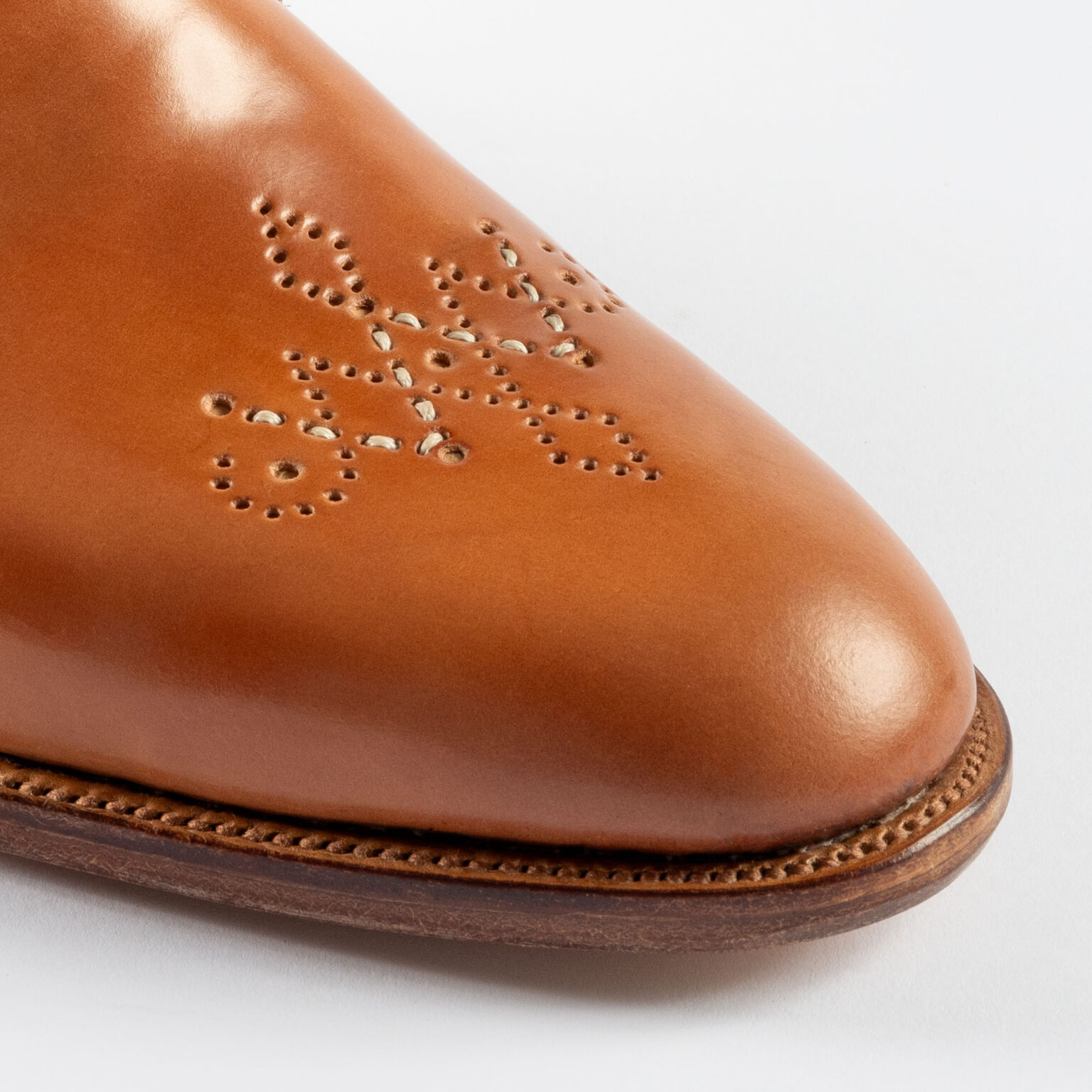 Closeup of signature E.Woodford medallion on Newport Gibson in Natural Horween Shell Cordovan