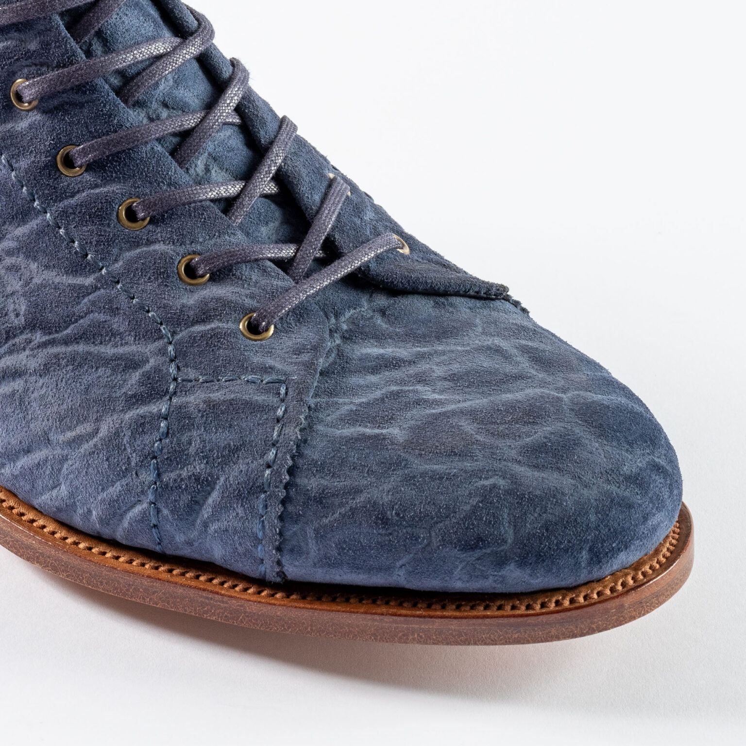 Closeup of vamp and toe on Woburn Monkey Boot in Navy CF Stead Janus Calf with Edwin emboss